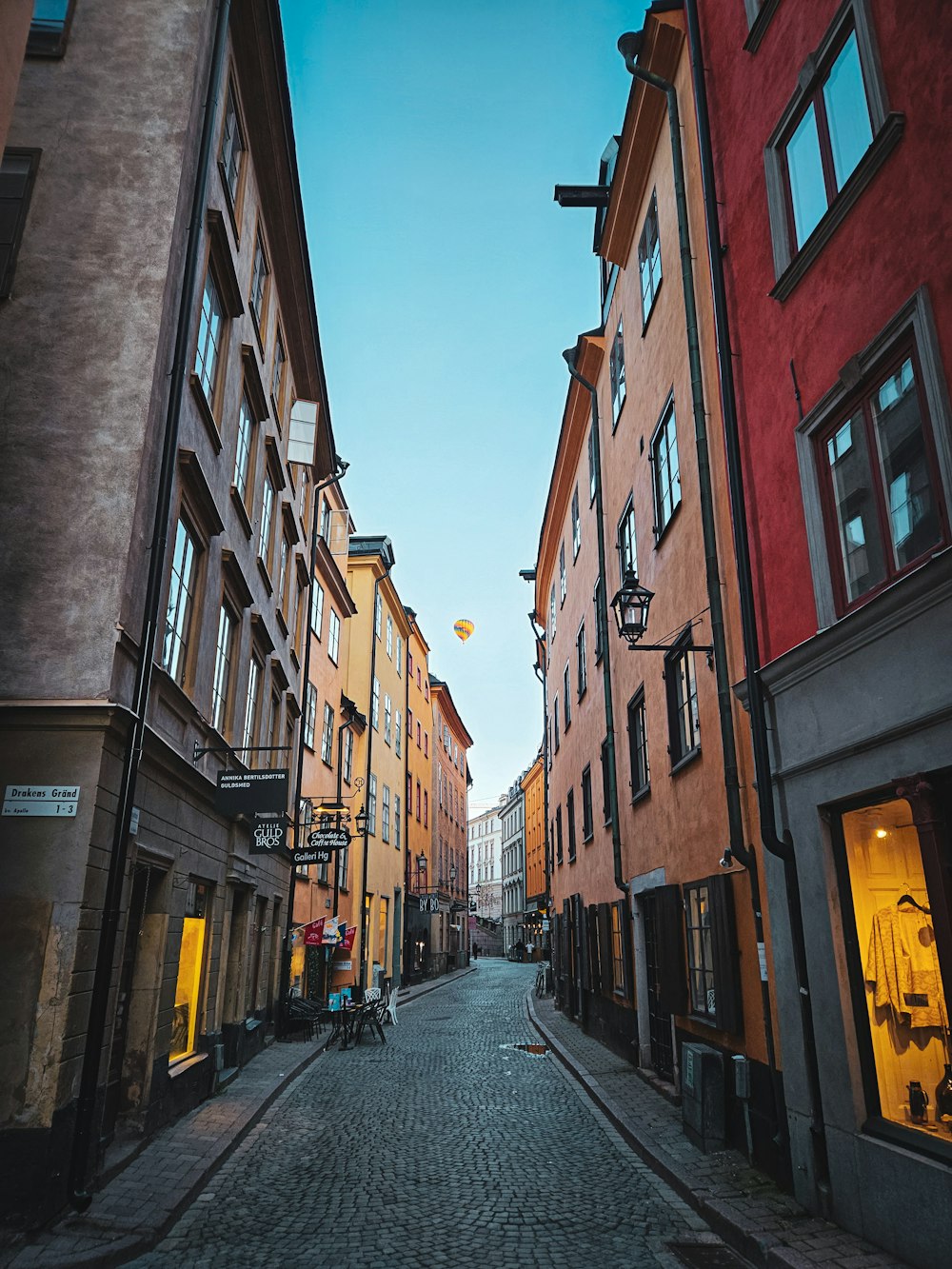 a cobblestone street lined with tall buildings