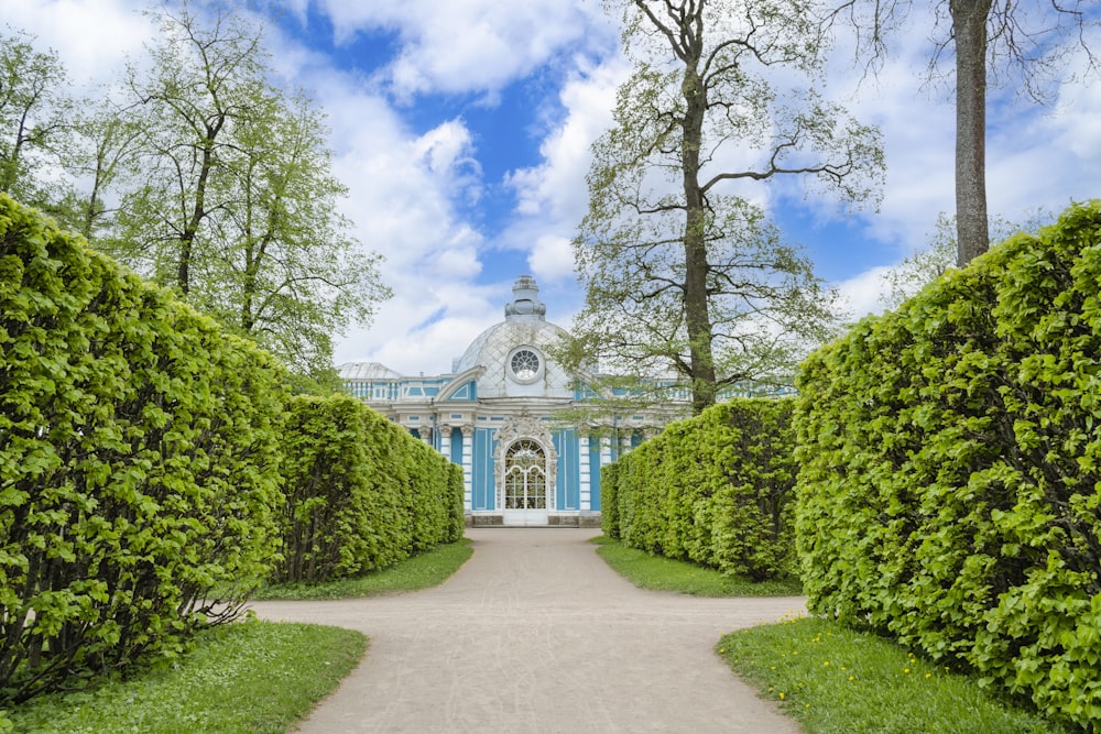 a large building with a blue roof surrounded by trees