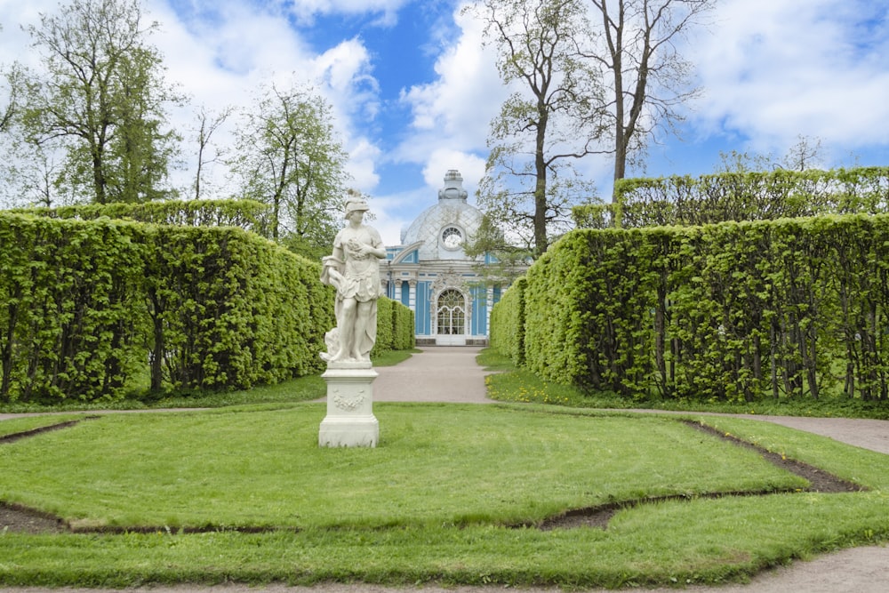 a garden with a statue in the middle of it