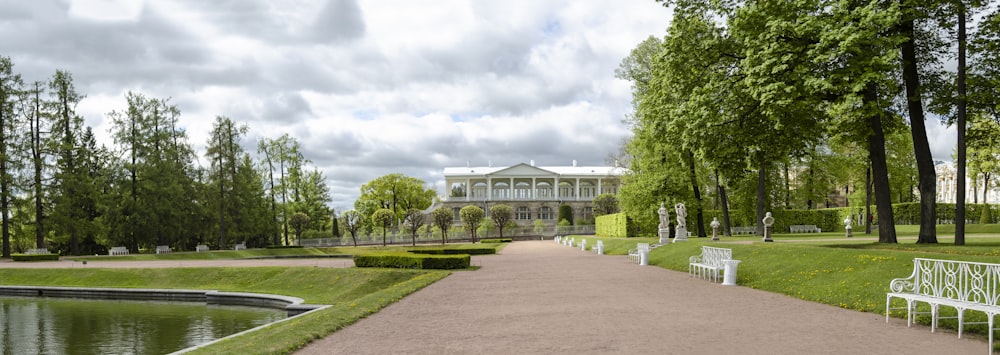 a park with benches and a pond in the middle of it