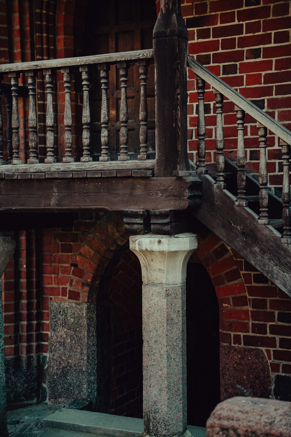 an old brick building with a wooden balcony