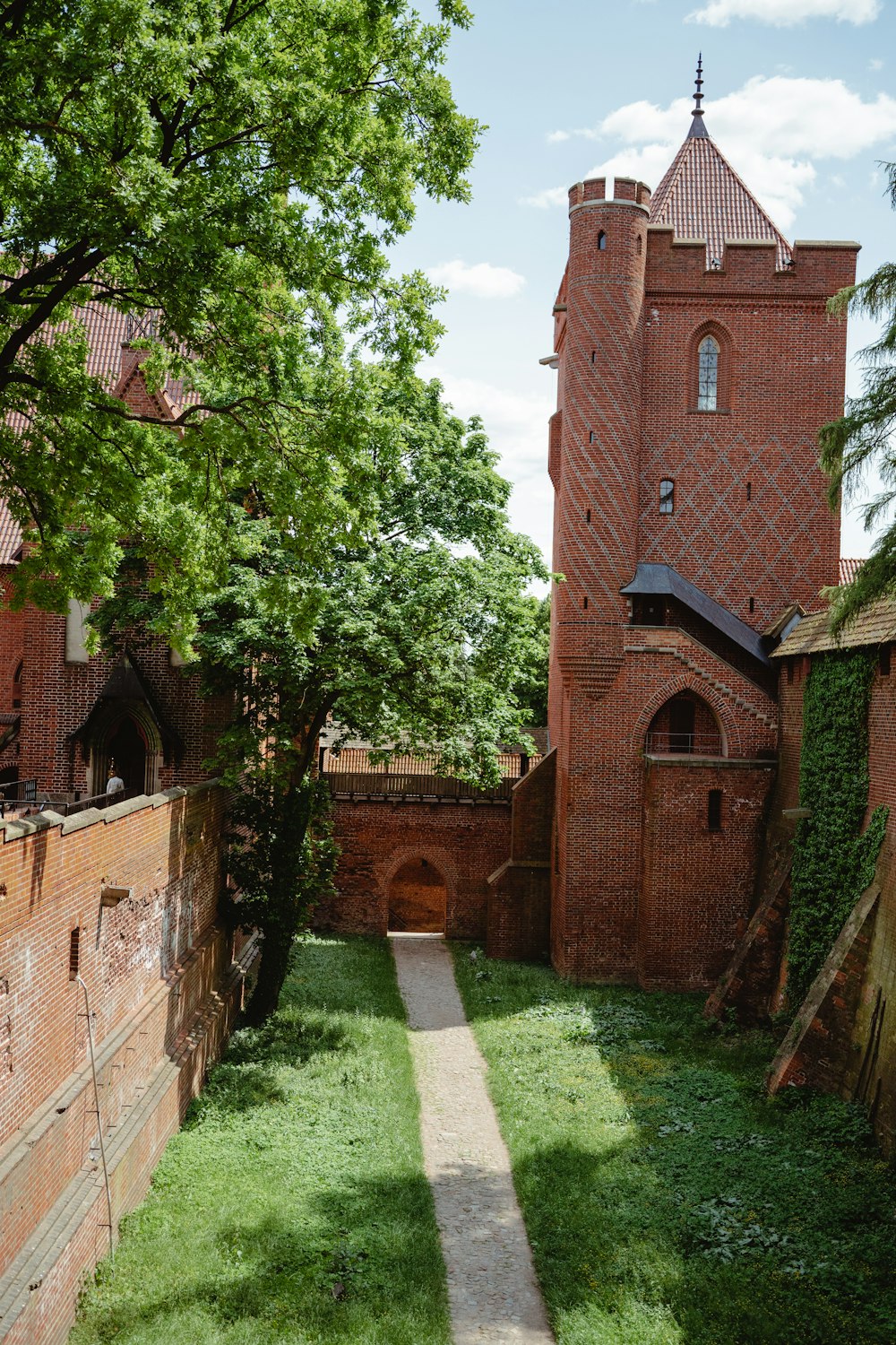 a brick building with a clock tower in the background