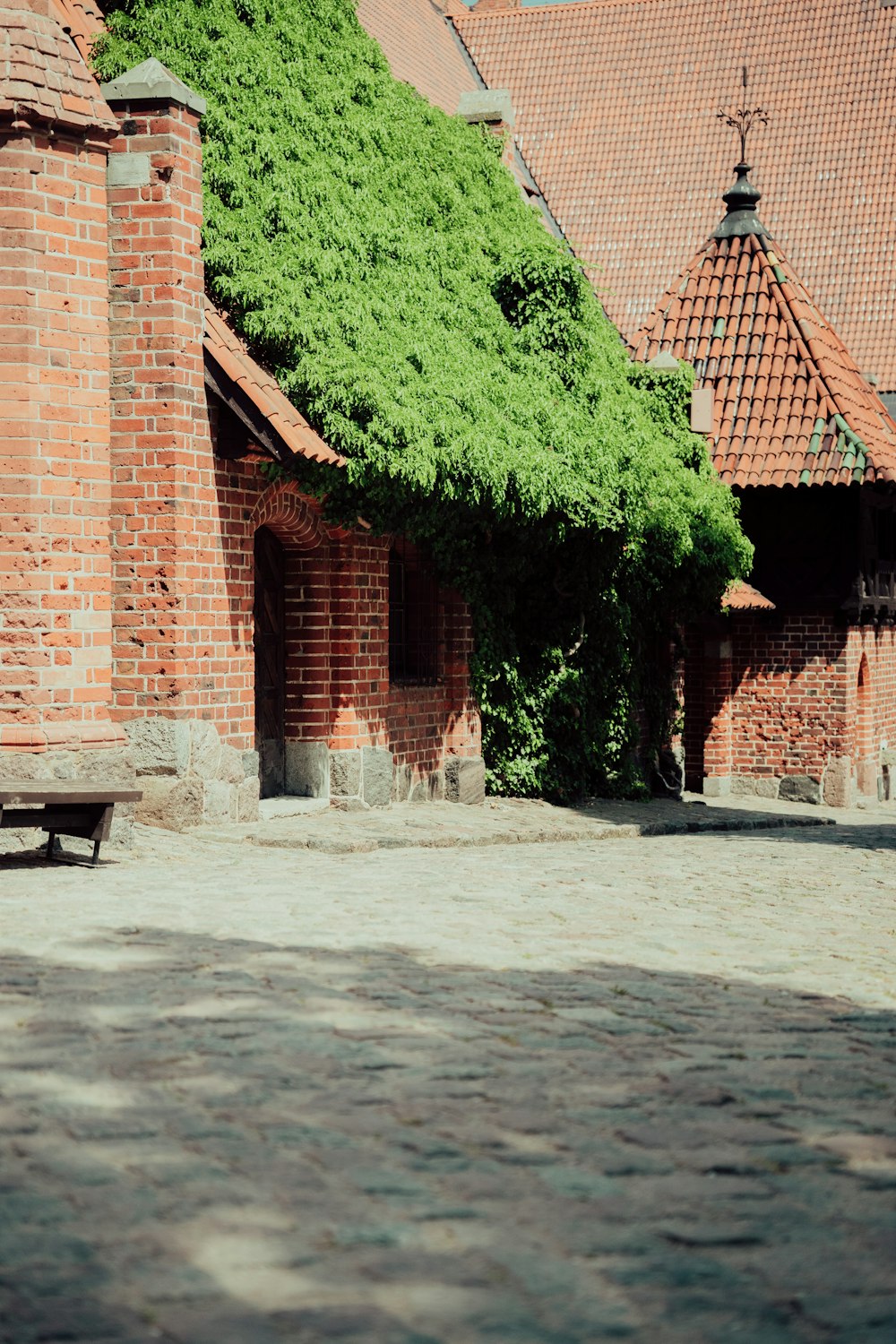 a brick building with a bench in front of it