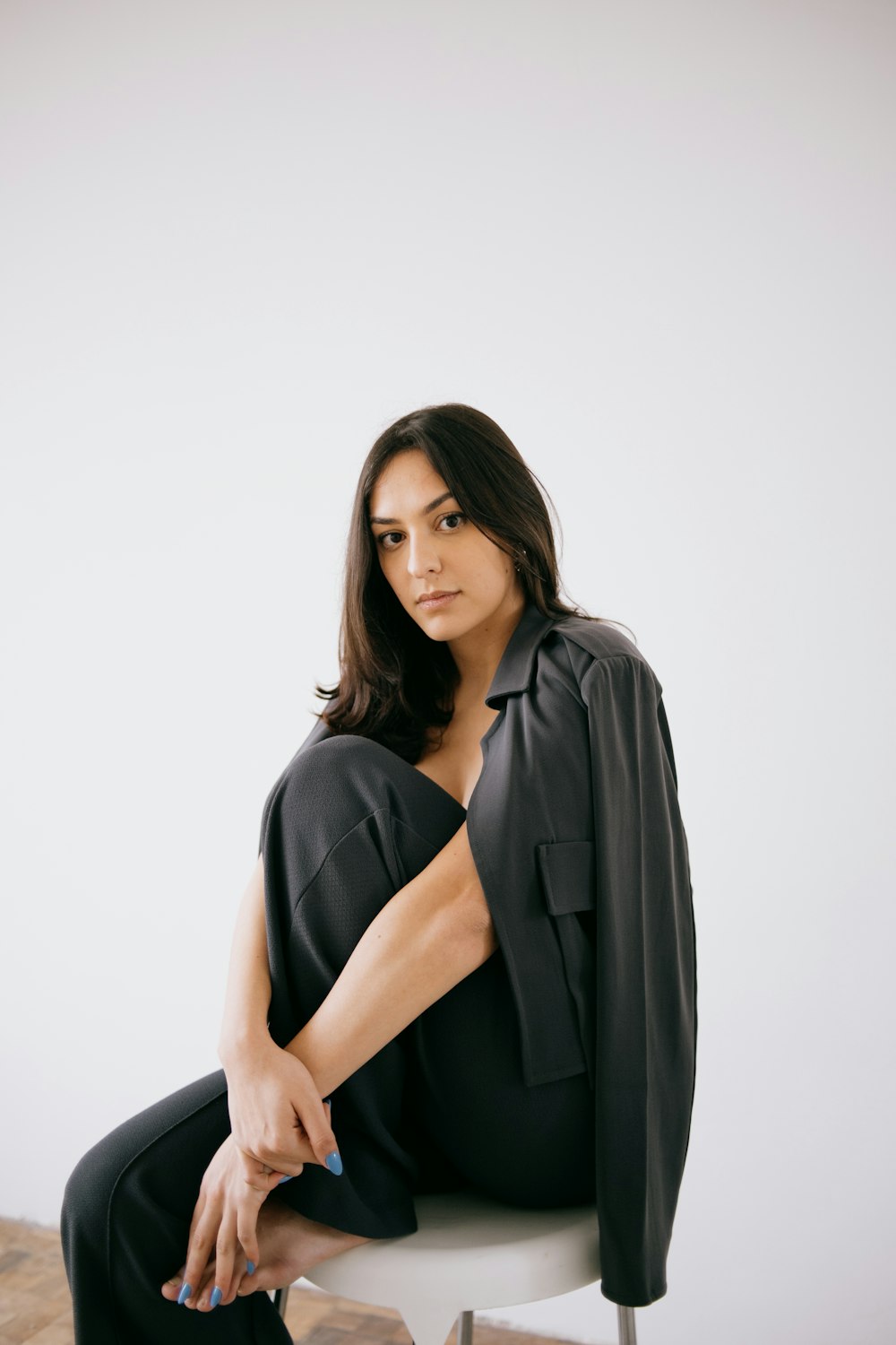 a woman sitting on top of a white chair