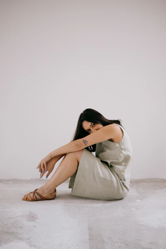 a woman sitting on the floor with her legs crossed