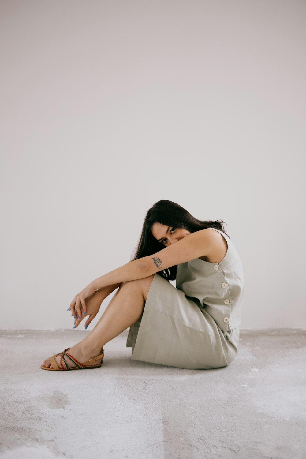 a woman sitting on the floor with her legs crossed