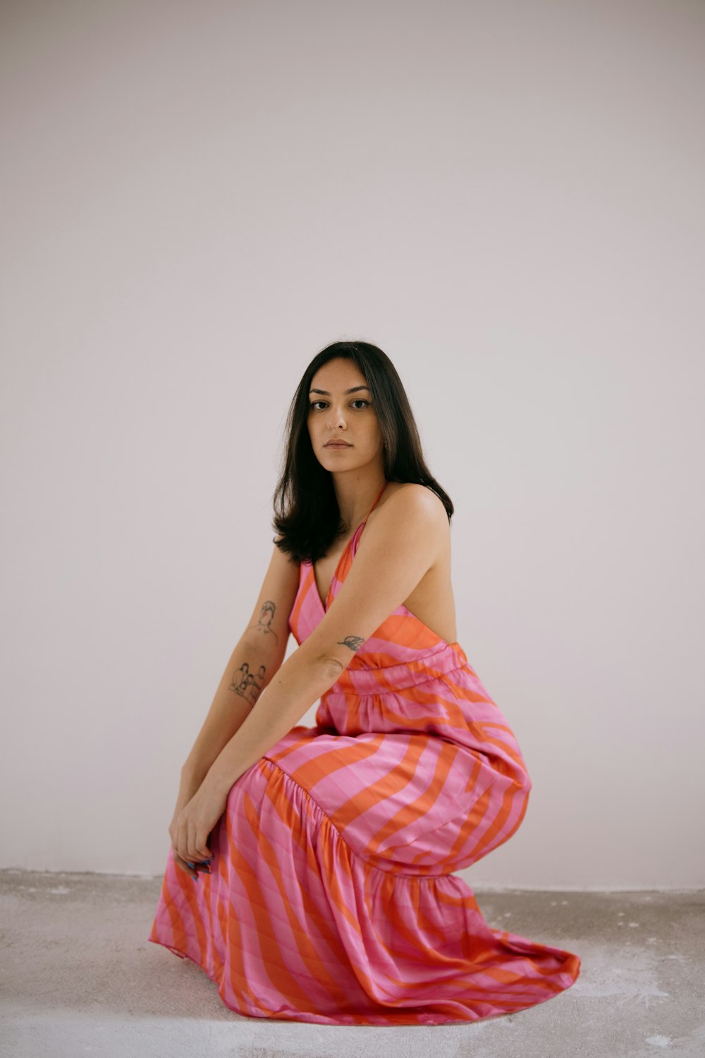 a woman in a pink and red striped dress