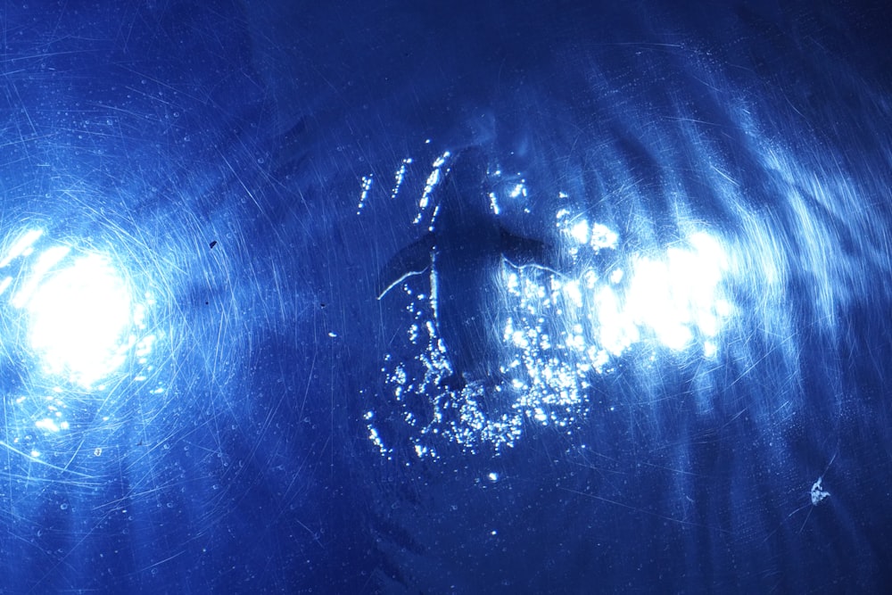 a close up of a water surface with light reflecting off of it