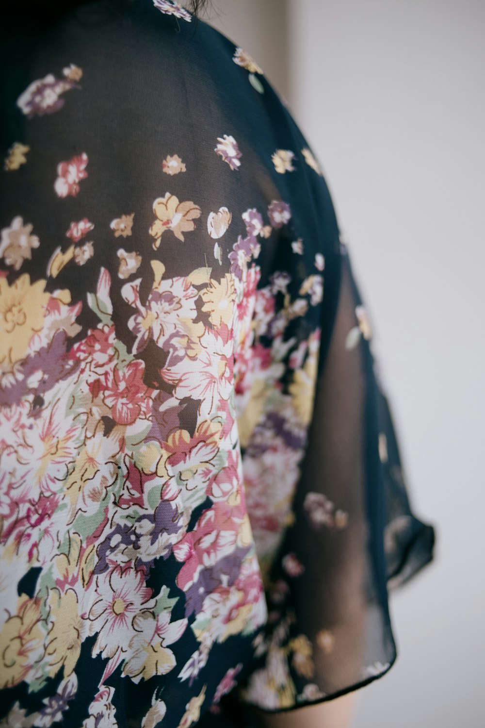 a close up of a woman's shirt with flowers on it