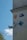 A wall is adorned with various artistic designs and graphics, including a depiction of a stylized face, a cartoon character in blue, and a relief sculpture of an angelic face with wings. There's also an abstract pattern on a blue square plaque.