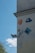 A wall is adorned with various artistic designs and graphics, including a depiction of a stylized face, a cartoon character in blue, and a relief sculpture of an angelic face with wings. There's also an abstract pattern on a blue square plaque.