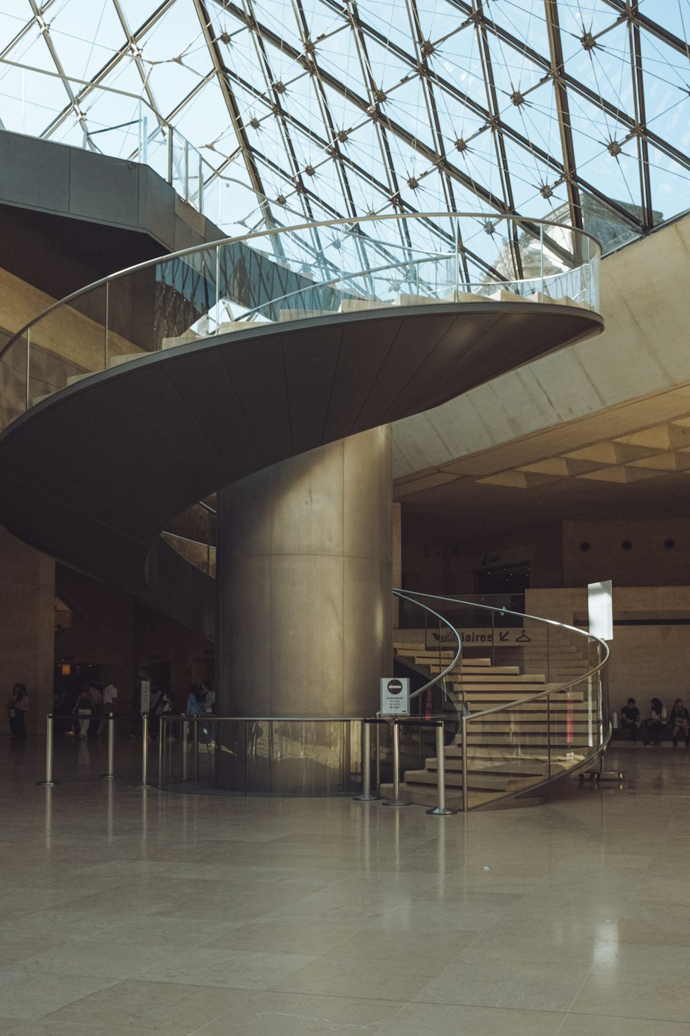 a building with a spiral staircase and a glass roof