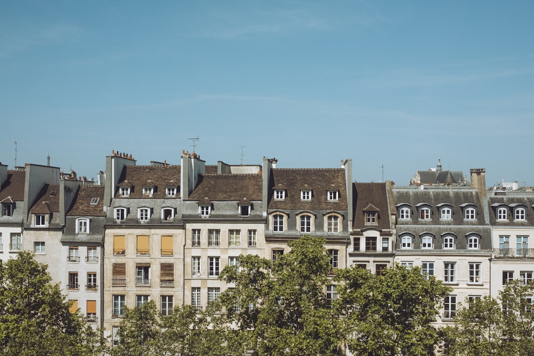a row of buildings with trees in front of them,
