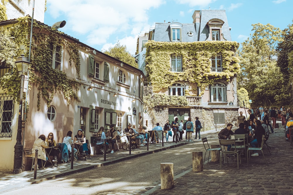 a group of people sitting outside of a building