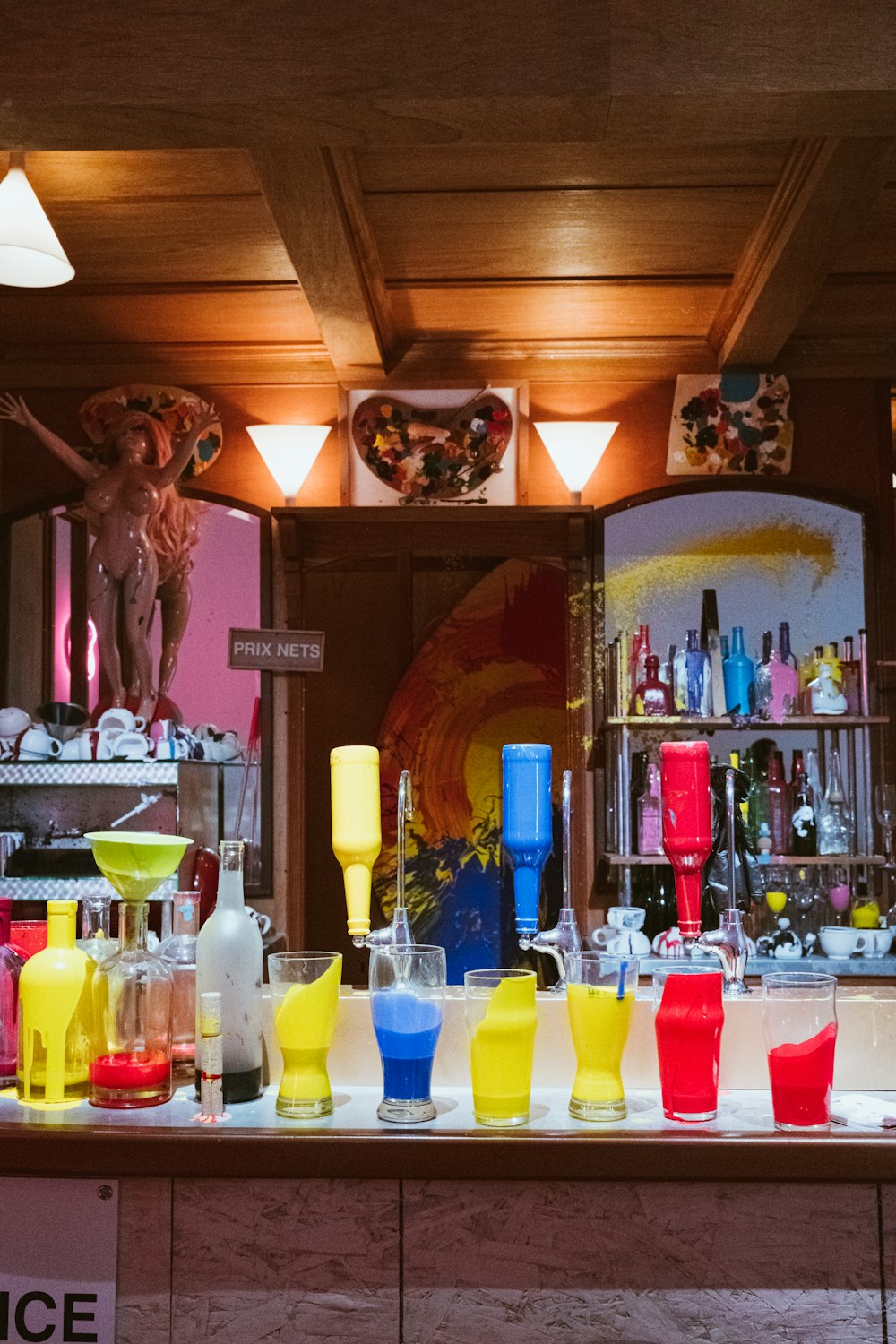 a bar filled with lots of different colored glasses