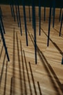 a wooden floor with many sticks sticking out of it