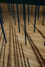a wooden floor with many sticks sticking out of it