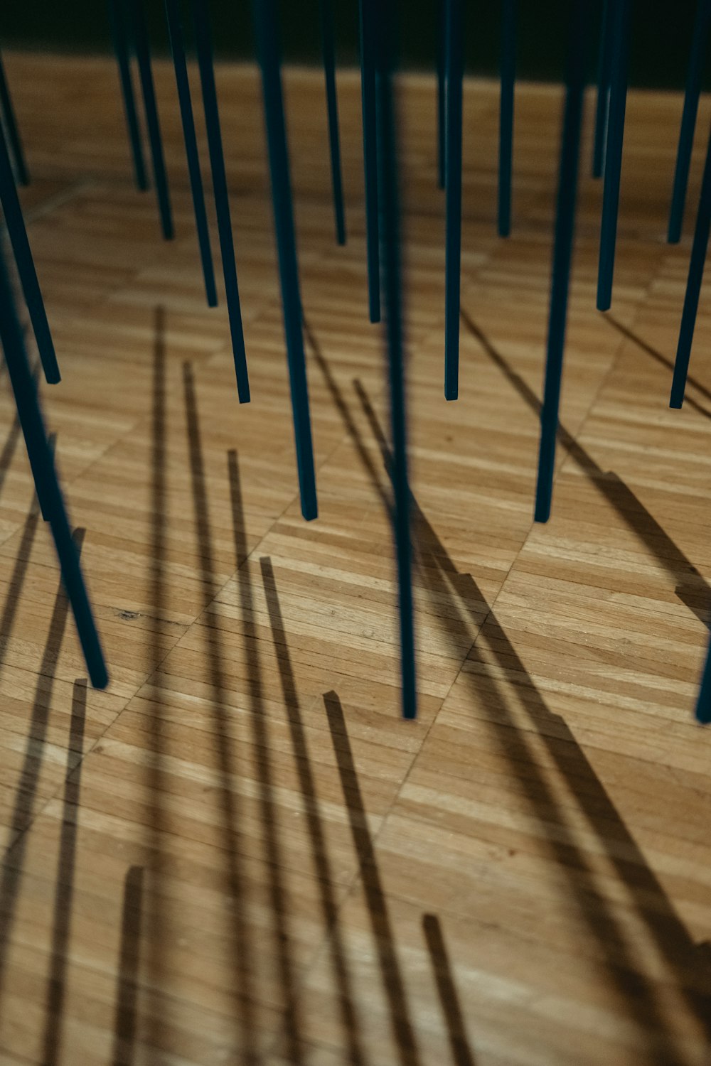 a wooden floor with many sticks sticking out of it