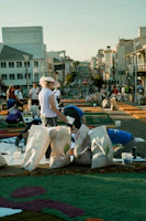 Youth collaborating on a creative project, surrounded by colorful materials and bright sunlight.