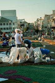 A group of street artists collaborating on a large mural.