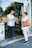 Happy customer holding a shopping bag from Redconexión in front of the store.