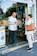 Happy customer holding a shopping bag from Redconexión in front of the store.