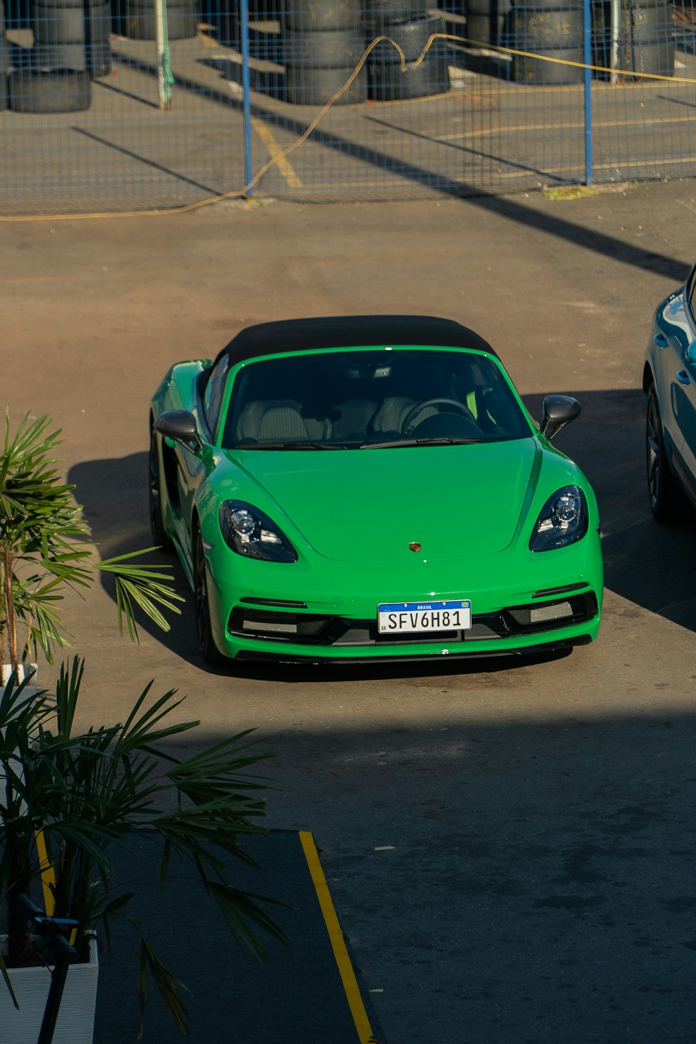two green sports cars parked next to each other