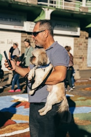 Close-up of a pet owner registering their dog's information on a smartphone.
