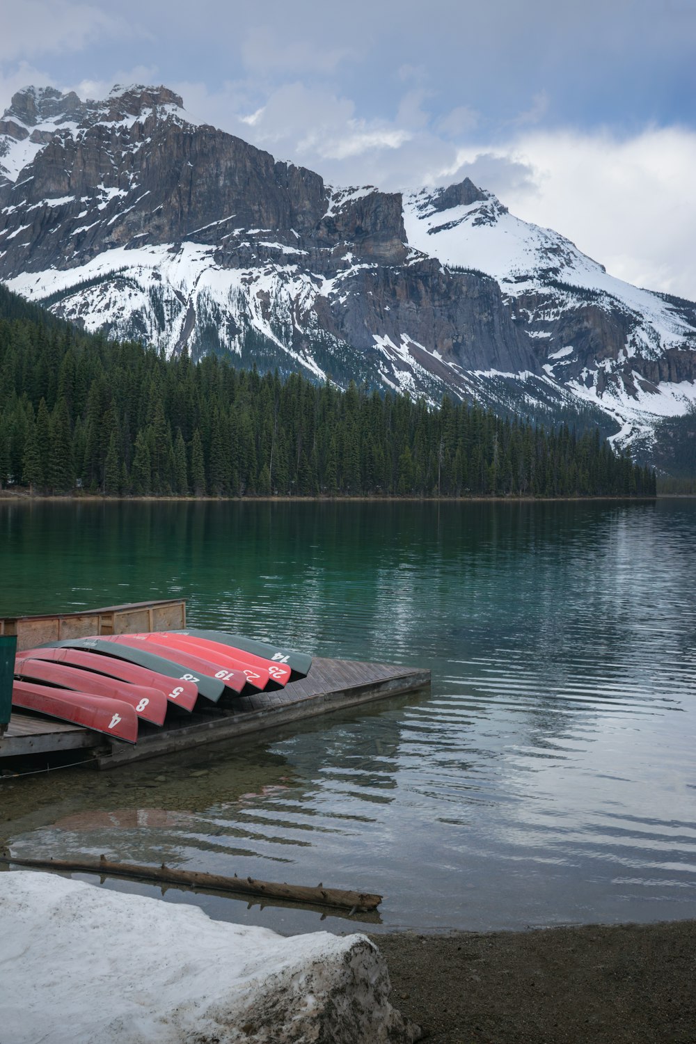 a red canoe sitting on top of a wooden dock