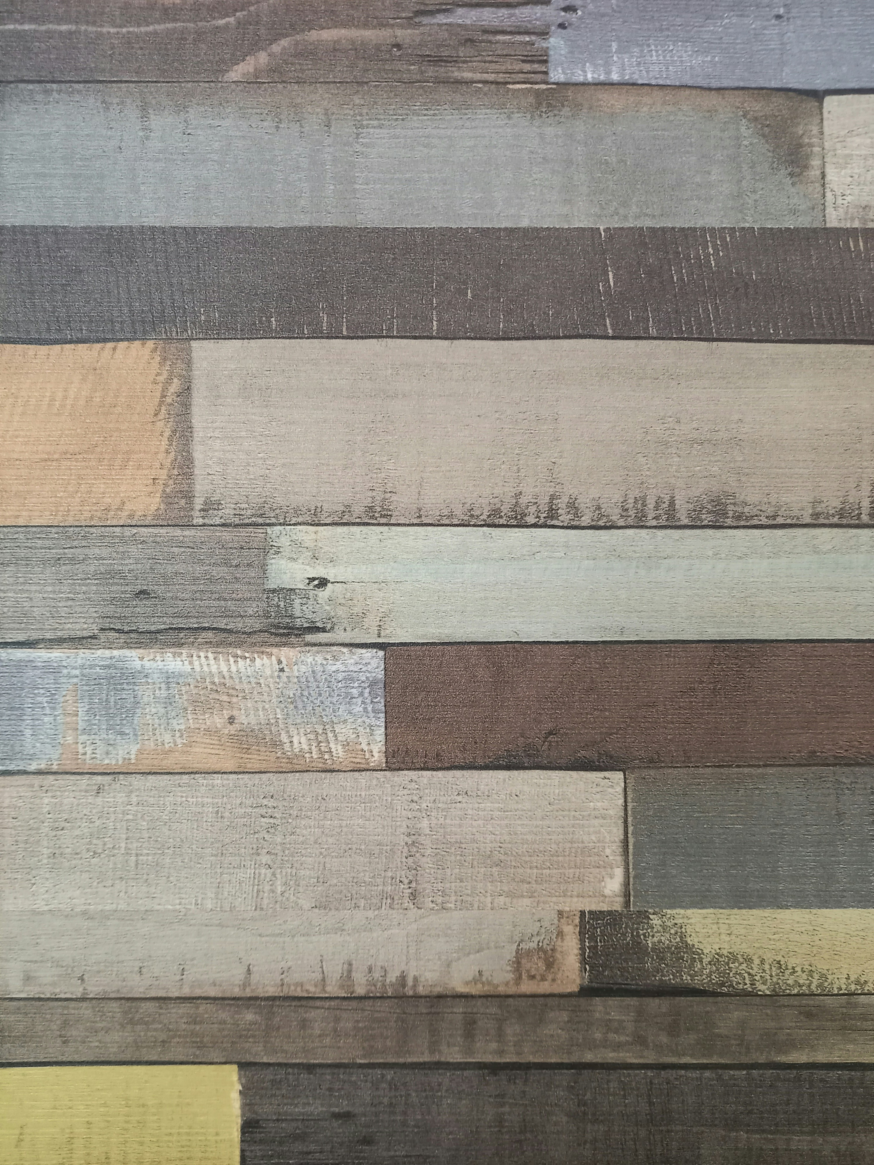 a close up of a wooden wall with different colors