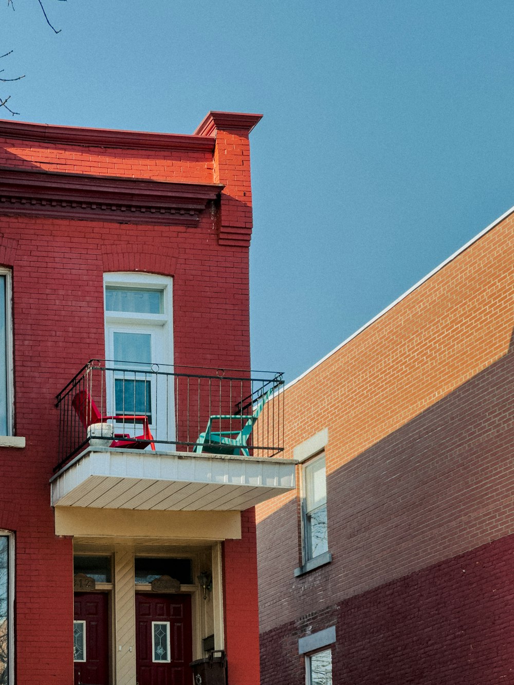 a red brick building with a balcony and balconies