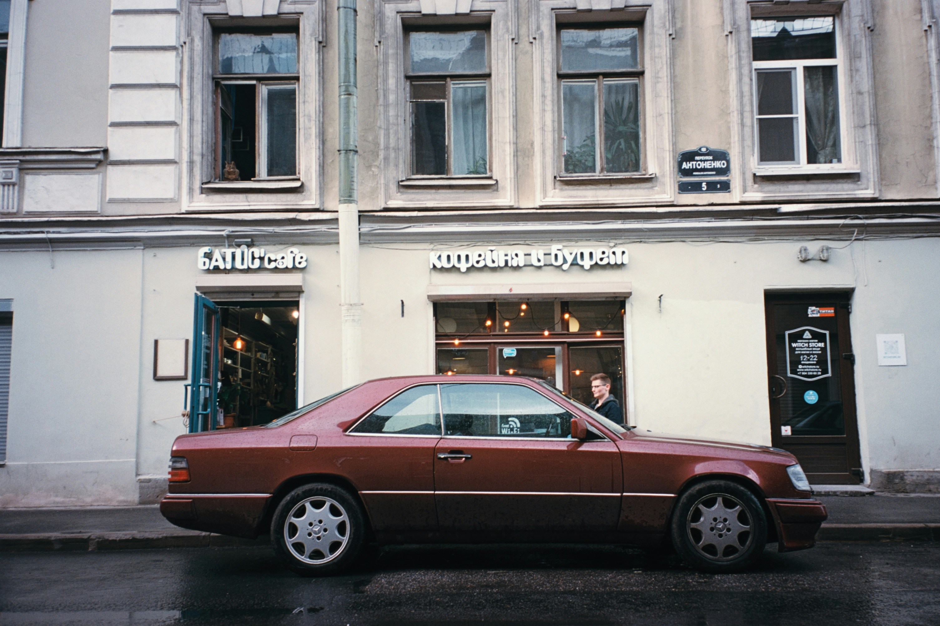 a red car parked in front of a building
