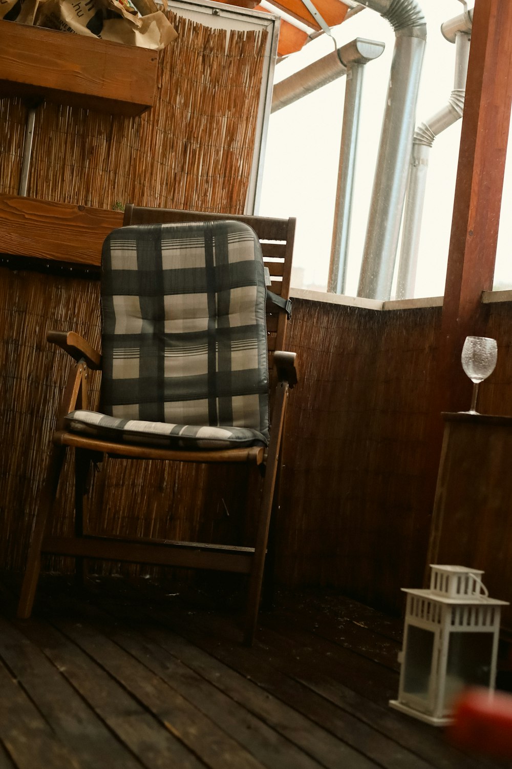 a chair sitting on top of a wooden floor next to a window