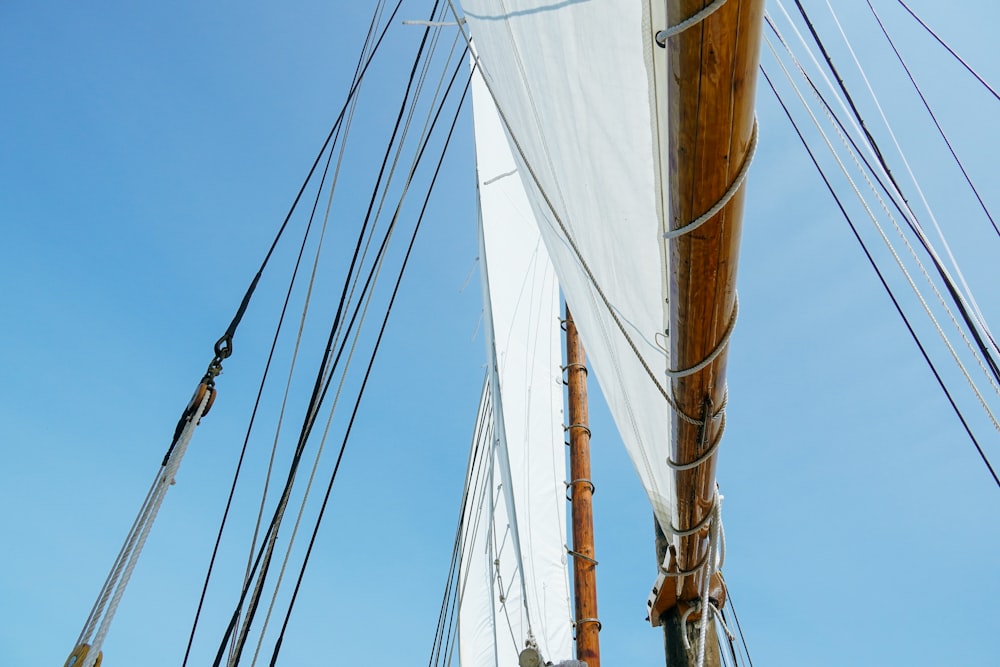 a white sail boat with a lot of ropes on it