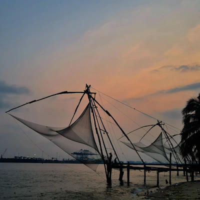 Colorful stilt fishermen casting nets against a golden sunset on the south coast.