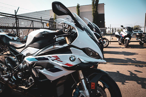 A lineup of dirt bikes and pit bikes ready for off-road adventure on a sunny day.