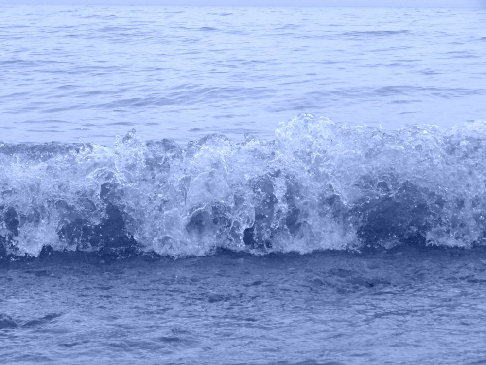 a man riding a wave on top of a surfboard