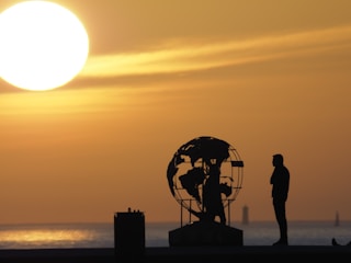 a person standing next to a large metal object