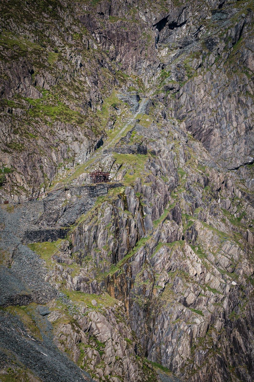 an aerial view of a mountain with a road going through it