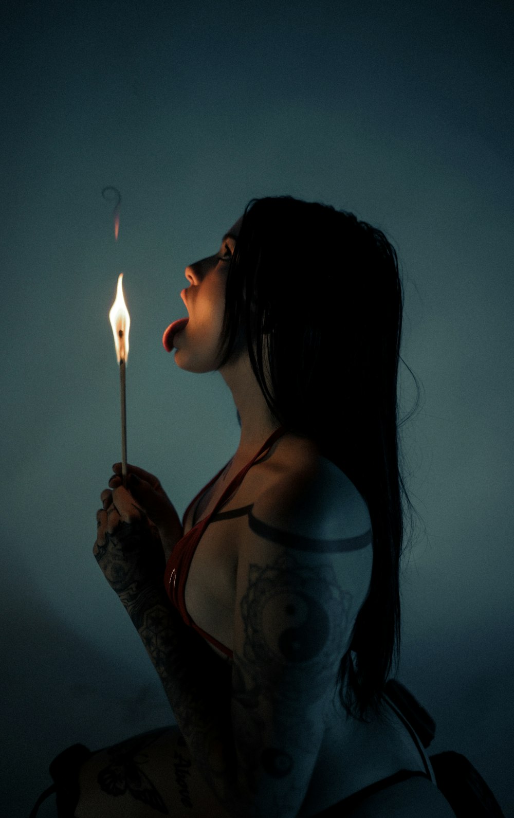 a woman holding a lit candle in her hand