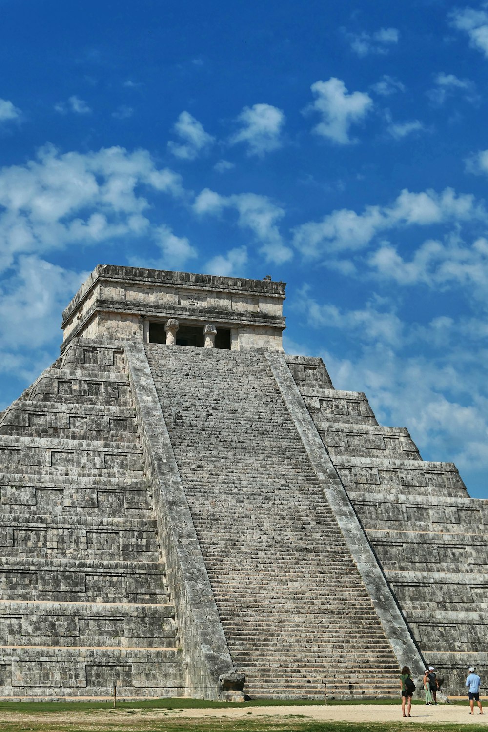 a group of people standing in front of a pyramid