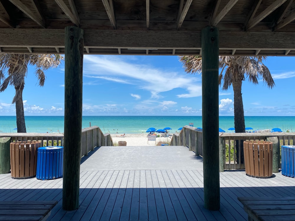 a view of the beach from a covered walkway