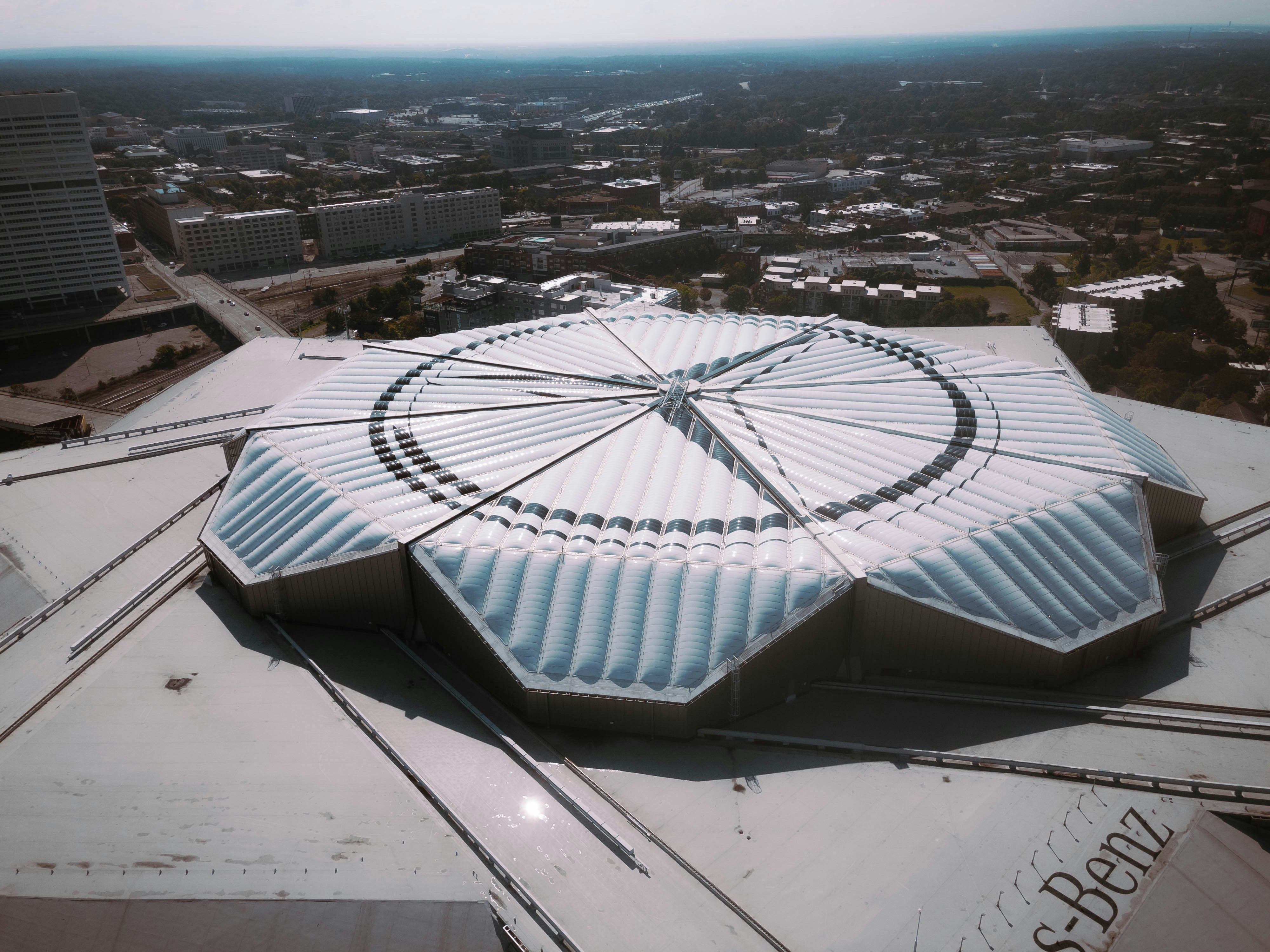 an aerial view of a building with a circular roof, 