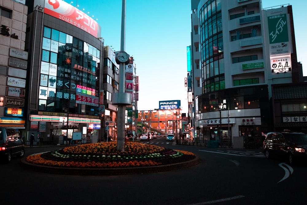 a city street with a clock in the middle of it