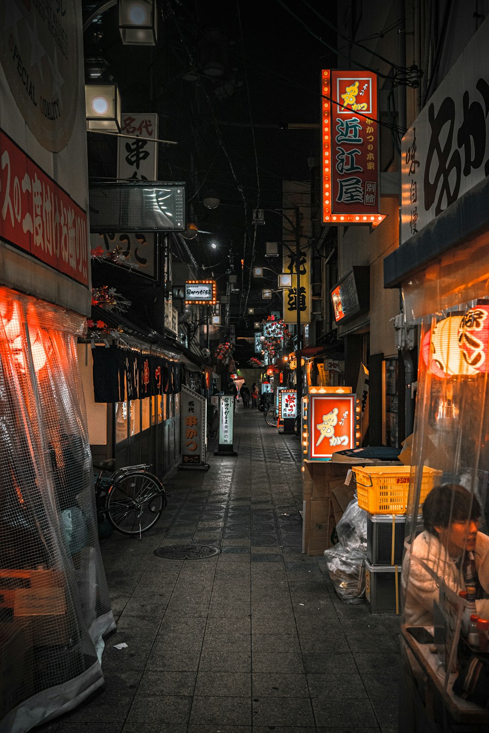 a person sitting at a table on a sidewalk