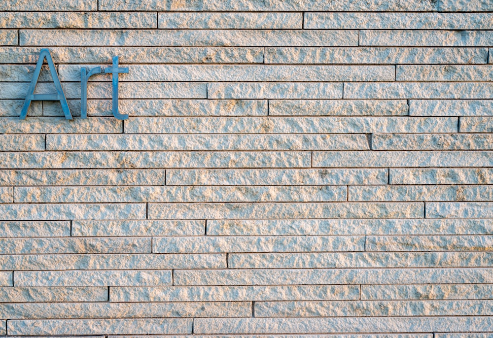 a brick wall with a blue sign on it