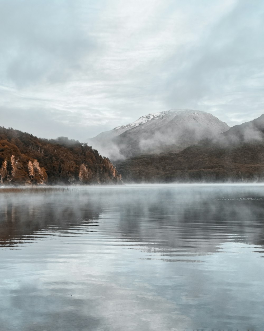 a body of water with mountains in the background