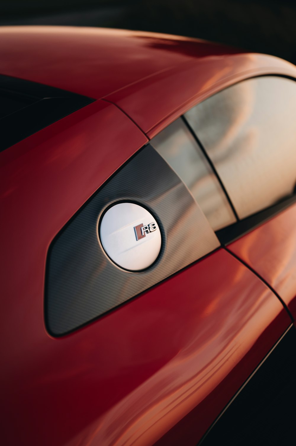 a close up of a red sports car's side view mirror