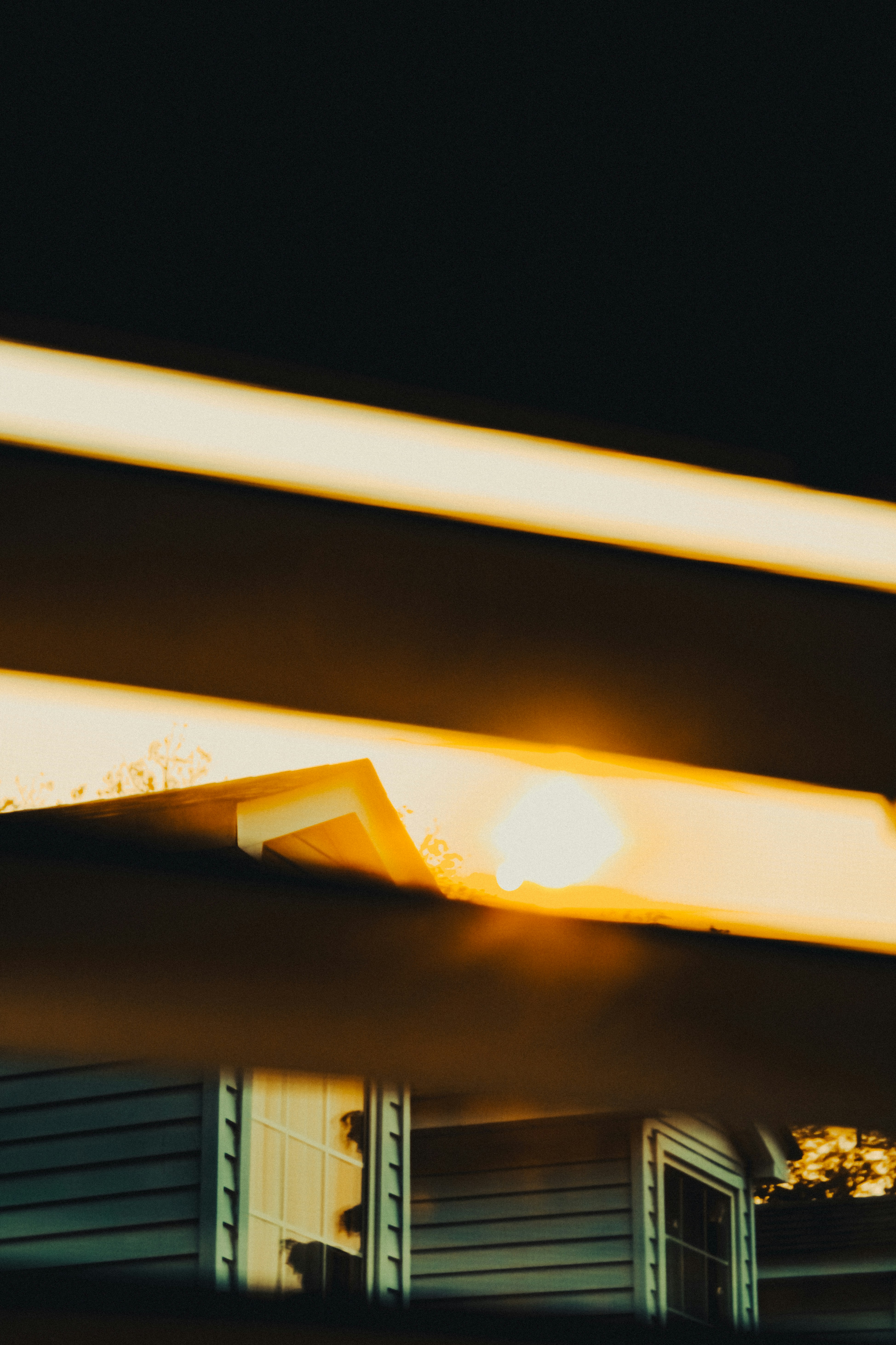 A light shines brightly on a house at night photo – Free City Image on  Unsplash, image size:3000x4500