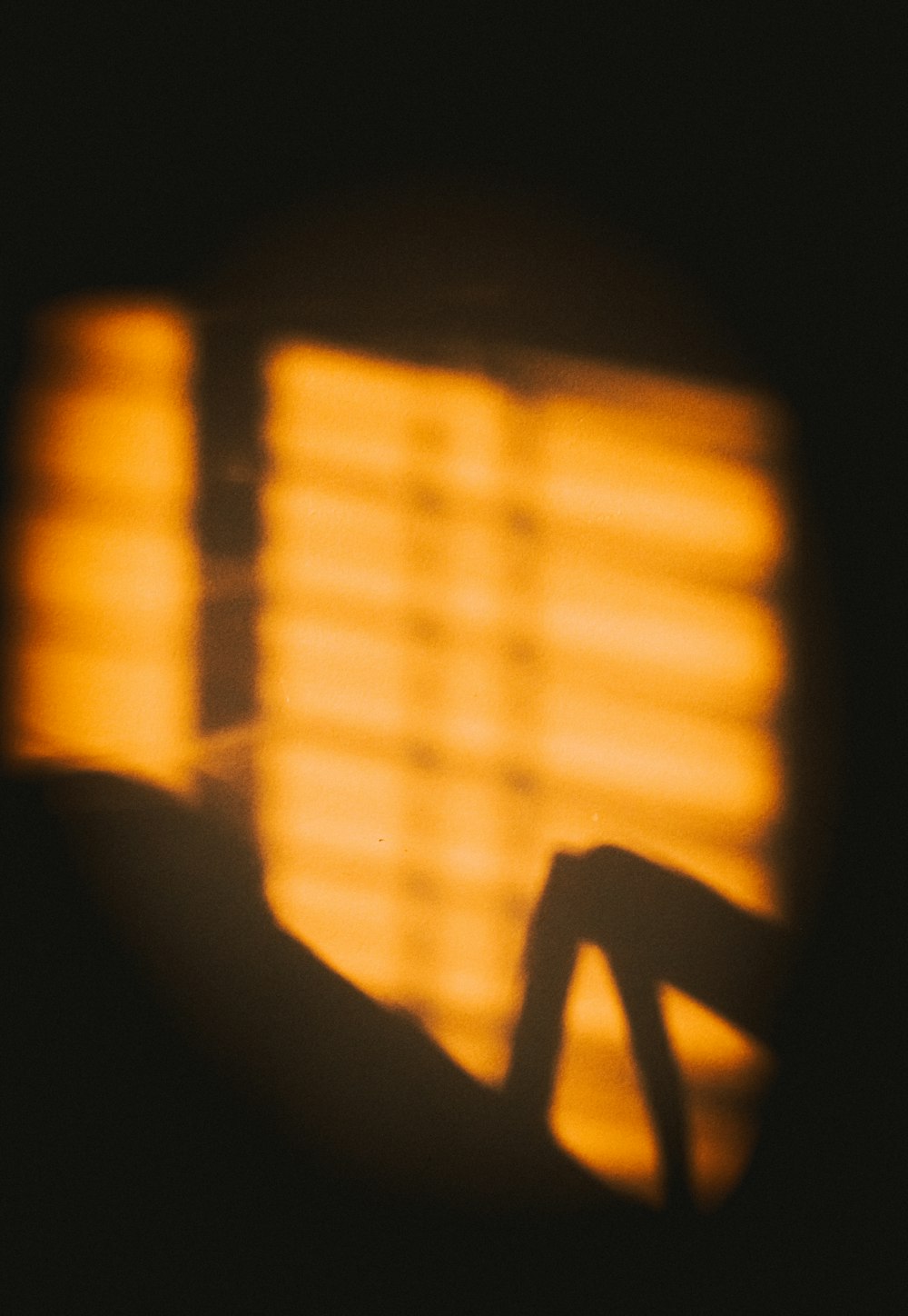 a close up of a person's hand in front of a window